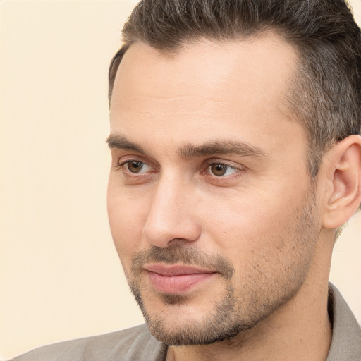 Joyful white adult male with short  brown hair and brown eyes