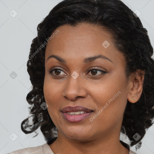 Joyful black adult female with medium  brown hair and brown eyes