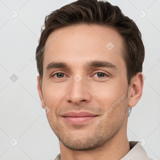 Joyful white young-adult male with short  brown hair and brown eyes