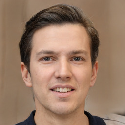 Joyful white adult male with short  brown hair and brown eyes