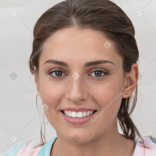 Joyful white young-adult female with medium  brown hair and grey eyes