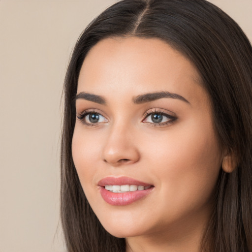 Joyful white young-adult female with long  black hair and brown eyes