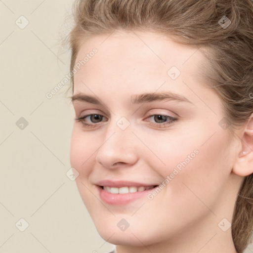 Joyful white young-adult female with long  brown hair and blue eyes