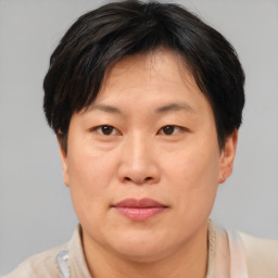 Joyful asian adult female with short  brown hair and brown eyes