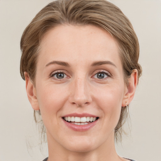 Joyful white young-adult female with medium  brown hair and green eyes