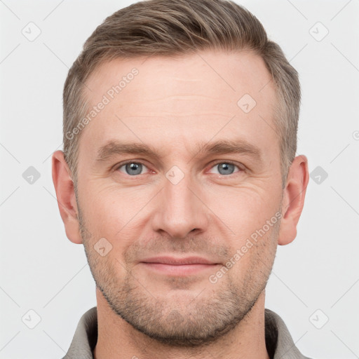 Joyful white adult male with short  brown hair and grey eyes