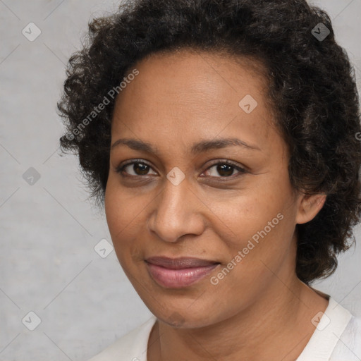 Joyful black adult female with medium  brown hair and brown eyes