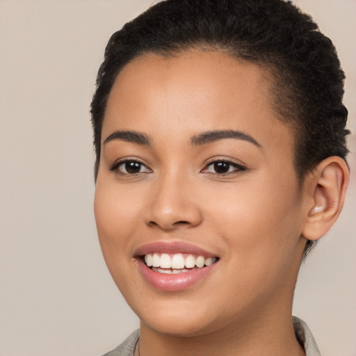 Joyful latino young-adult female with short  brown hair and brown eyes