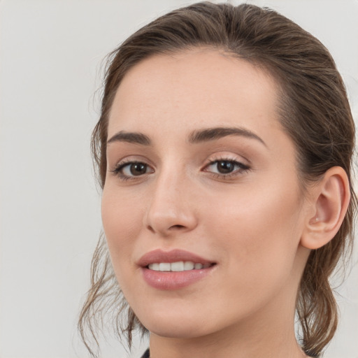 Joyful white young-adult female with medium  brown hair and grey eyes