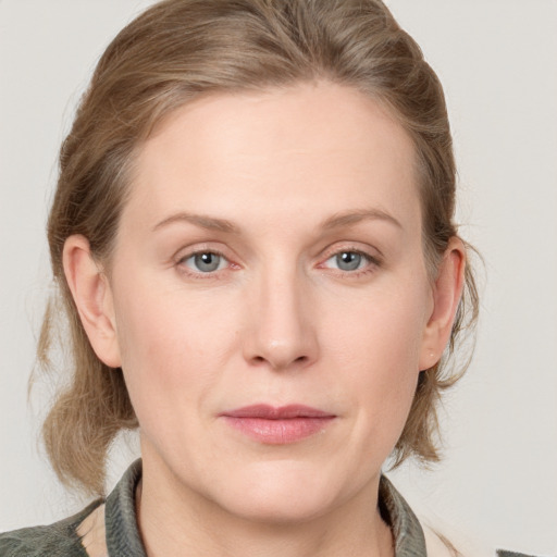 Joyful white young-adult female with medium  brown hair and blue eyes