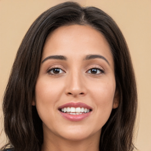 Joyful white young-adult female with long  brown hair and brown eyes