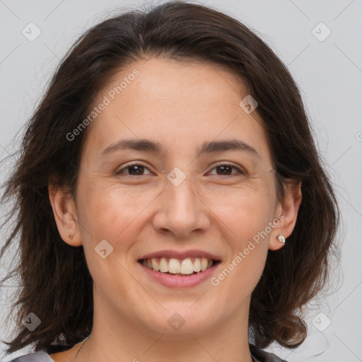 Joyful white adult female with medium  brown hair and brown eyes