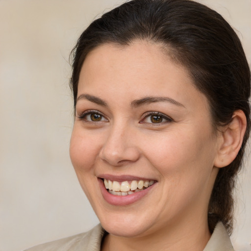 Joyful white young-adult female with medium  brown hair and brown eyes