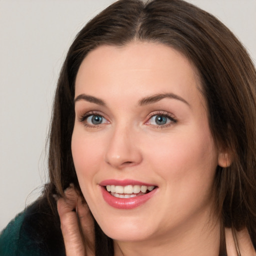 Joyful white young-adult female with long  brown hair and grey eyes