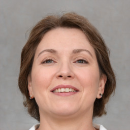 Joyful white adult female with medium  brown hair and brown eyes