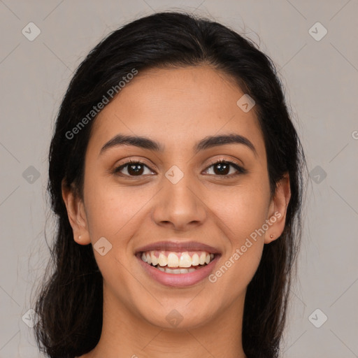 Joyful latino young-adult female with long  brown hair and brown eyes