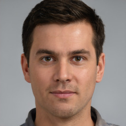 Joyful white young-adult male with short  brown hair and brown eyes