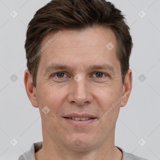 Joyful white adult male with short  brown hair and brown eyes