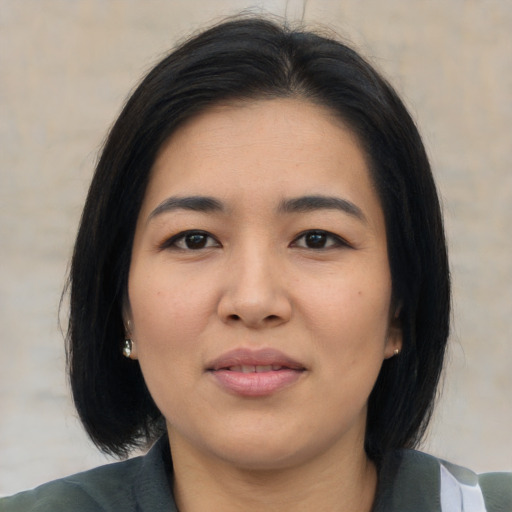 Joyful asian young-adult female with medium  black hair and brown eyes