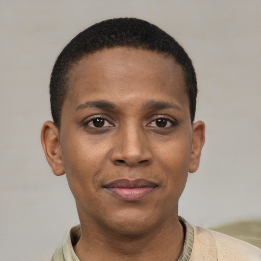 Joyful black young-adult female with short  black hair and brown eyes