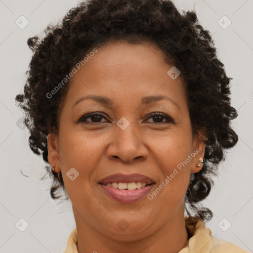 Joyful black adult female with medium  brown hair and brown eyes