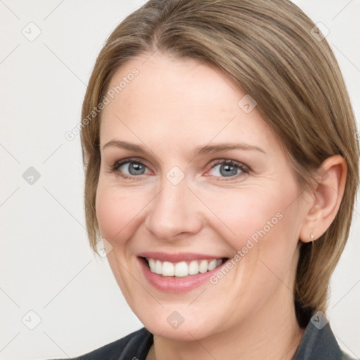 Joyful white young-adult female with medium  brown hair and grey eyes