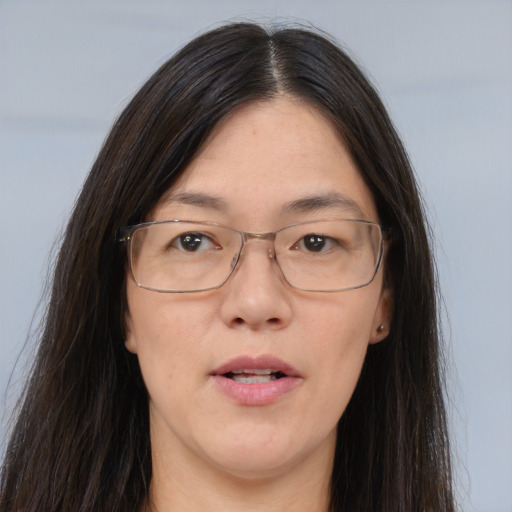 Joyful white adult female with long  brown hair and brown eyes