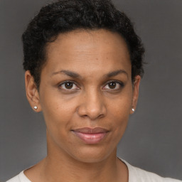 Joyful black adult female with short  brown hair and brown eyes