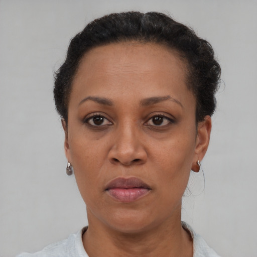 Joyful black adult female with short  brown hair and brown eyes