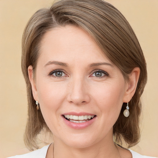 Joyful white young-adult female with medium  brown hair and grey eyes