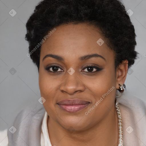 Joyful black young-adult female with short  brown hair and brown eyes