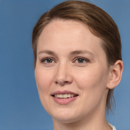 Joyful white young-adult female with medium  brown hair and grey eyes