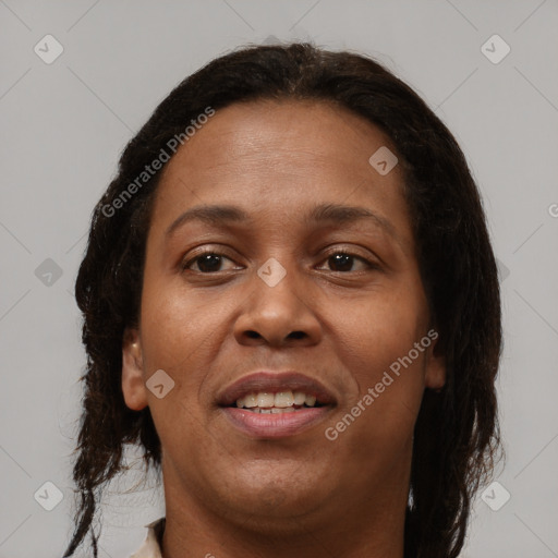 Joyful black adult female with long  brown hair and brown eyes