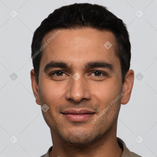 Joyful white young-adult male with short  black hair and brown eyes