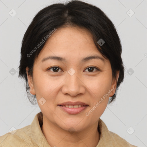 Joyful asian adult female with medium  brown hair and brown eyes