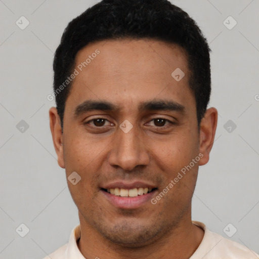 Joyful latino young-adult male with short  black hair and brown eyes