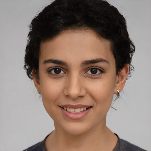 Joyful latino young-adult female with short  brown hair and brown eyes