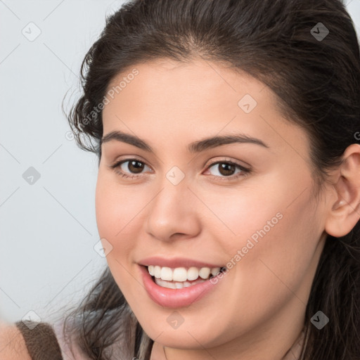 Joyful white young-adult female with long  brown hair and brown eyes