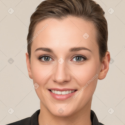 Joyful white young-adult female with short  brown hair and grey eyes