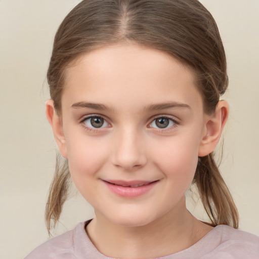 Joyful white child female with medium  brown hair and brown eyes