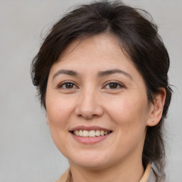 Joyful white adult female with medium  brown hair and brown eyes