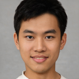 Joyful asian young-adult male with short  black hair and brown eyes