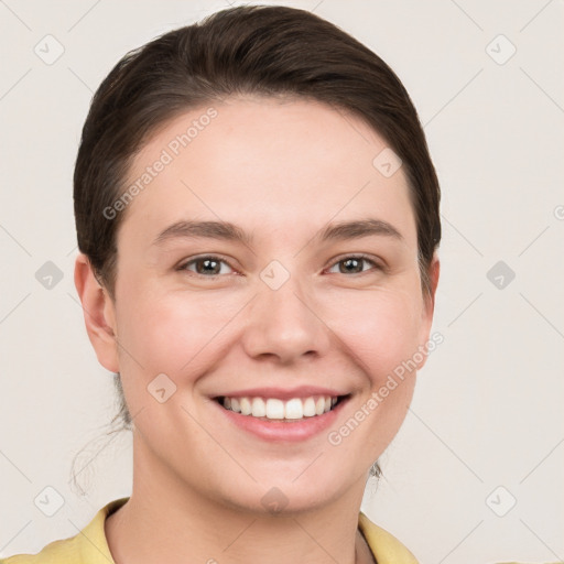 Joyful white young-adult female with short  brown hair and grey eyes