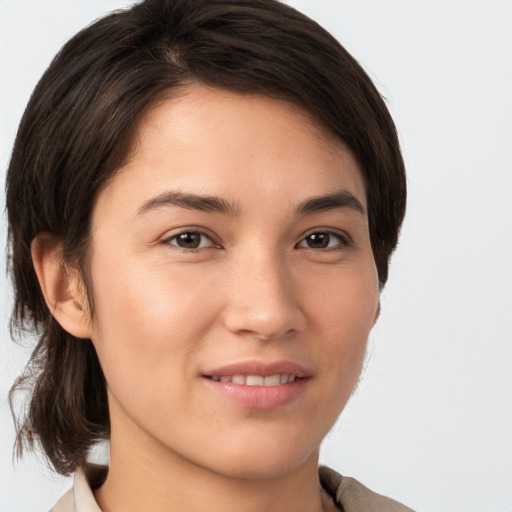 Joyful white young-adult female with medium  brown hair and brown eyes