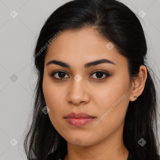 Joyful latino young-adult female with long  brown hair and brown eyes