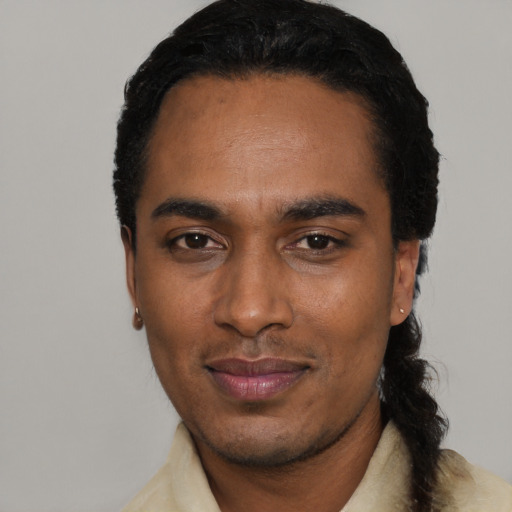 Joyful black young-adult male with short  black hair and brown eyes