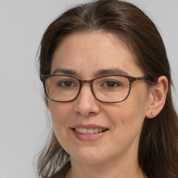 Joyful white adult female with long  brown hair and brown eyes