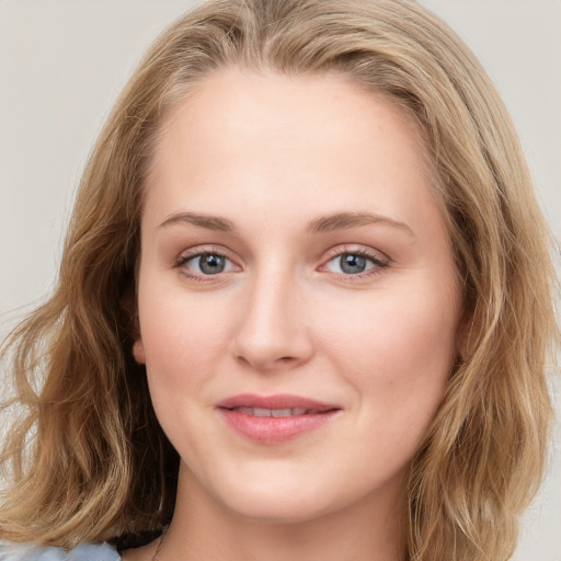 Joyful white young-adult female with long  brown hair and blue eyes