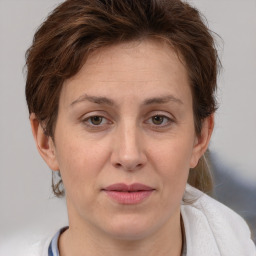 Joyful white adult female with medium  brown hair and grey eyes