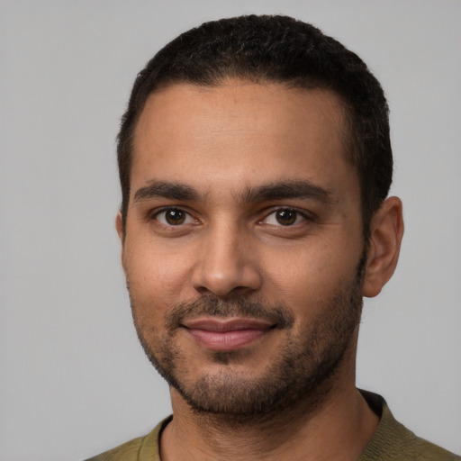 Joyful latino young-adult male with short  black hair and brown eyes